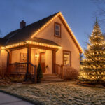 A festive home decorated with various exterior Christmas lights.
